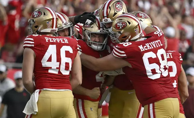 San Francisco 49ers place kicker Jake Moody, middle, celebrates with teammates after kicking the game winning field goal during the second half of an NFL football game against the Tampa Bay Buccaneers in Tampa, Fla., Sunday, Nov. 10, 2024. (AP Photo/Jason Behnken)