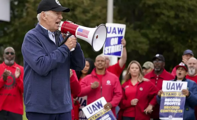 President Joe Biden joins striking United Auto Workers on the picket line, Tuesday, Sept. 26, 2023, in Van Buren Township, Mich. (AP Photo/Evan Vucci)