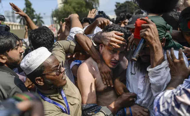 Students from anti-discrimination movements attack an Awami League supporter in Dhaka, Bangladesh, Sunday, Nov. 10, 2024. (AP Photo/Mahmud Hossain Opu)