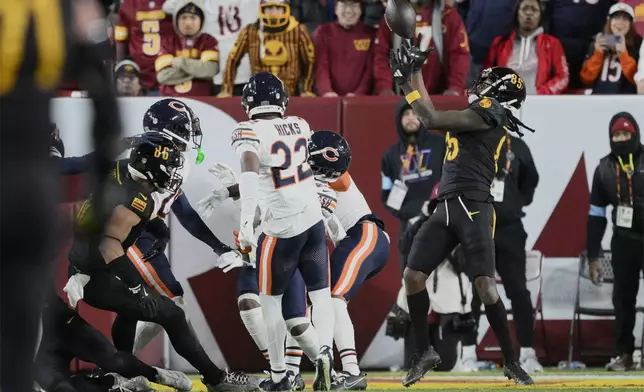 Washington Commanders wide receiver Noah Brown (85) catches a 52-yard touchdown pass in the end zone as time expires to give the Commanders an 18-15 win over the Chicago Bears in an NFL football game Sunday, Oct. 27, 2024, in Landover, Md. (AP Photo/Nick Wass)