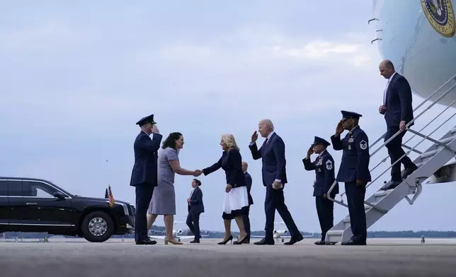 President Joe Biden and first lady Jill Biden walk down the steps of Air Force One at Andrews Air Force Base, Md., and greet Col. William McDonald, Vice Commander, 89th Airlift Wing and his wife Diana, Friday, June 9, 2023, after a visit to North Carolina. (AP Photo/Susan Walsh)