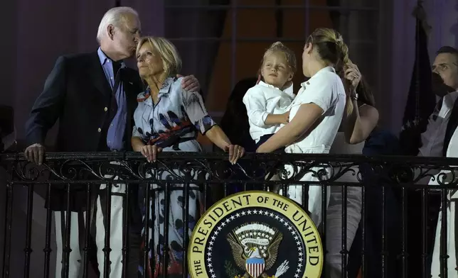 President Joe Biden kisses first lady Jill Biden during a fireworks show at a Fourth of July celebration at the White House in Washington, Tuesday, July 4, 2023. (AP Photo/Susan Walsh)