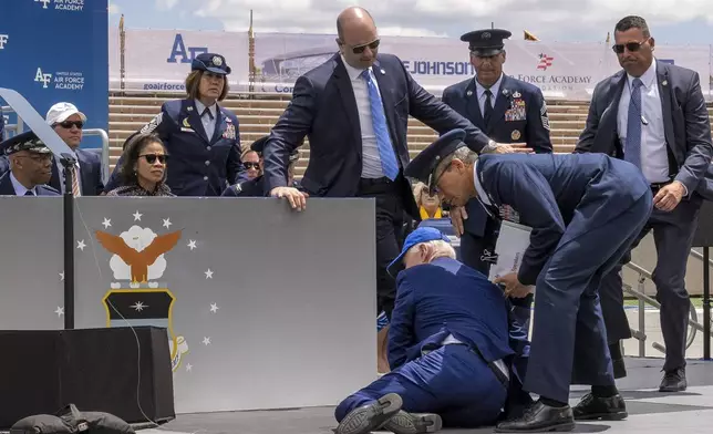 President Joe Biden falls on stage during the 2023 United States Air Force Academy Graduation Ceremony at Falcon Stadium, Thursday, June 1, 2023, at the United States Air Force Academy in Colorado Springs, Colo. (AP Photo/Andrew Harnik)