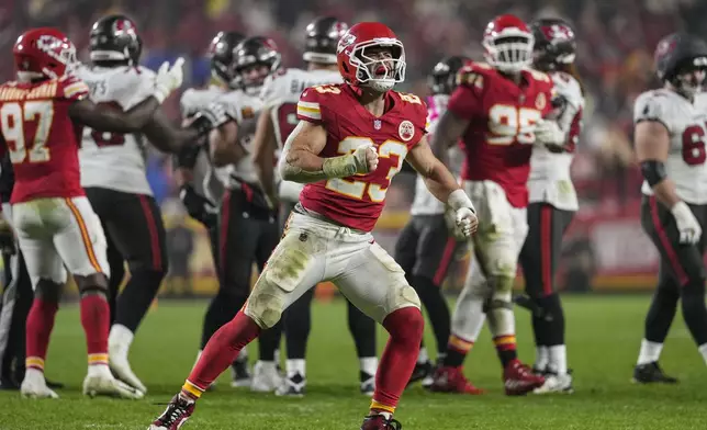 Kansas City Chiefs linebacker Drue Tranquill (23) celebrates a defensive play against the Tampa Bay Buccaneers during the second half of an NFL football game, Monday, Nov. 4, 2024, in Kansas City, Mo. (AP Photo/Ed Zurga)