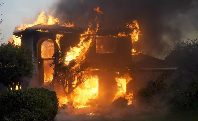 A fire burns a house in the Mountain fire, Wednesday, Nov. 6, 2024, in Camarillo, Calif. (AP Photo/Marcio Jose Sanchez)