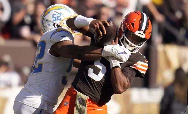 Los Angeles Chargers linebacker Khalil Mack (52) sacks Cleveland Browns quarterback Jameis Winston (5) for a 6-yard loss in the first half of an NFL football game Sunday, Nov. 3, 2024, in Cleveland. (AP Photo/Sue Ogrocki)