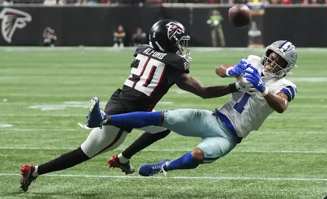 Dallas Cowboys wide receiver Jalen Tolbert (1) fails to pull in a pass against Atlanta Falcons cornerback Dee Alford (20) during the second half of an NFL football game, Sunday, Nov. 3, 2024, in Atlanta. (AP Photo/ Brynn Anderson)