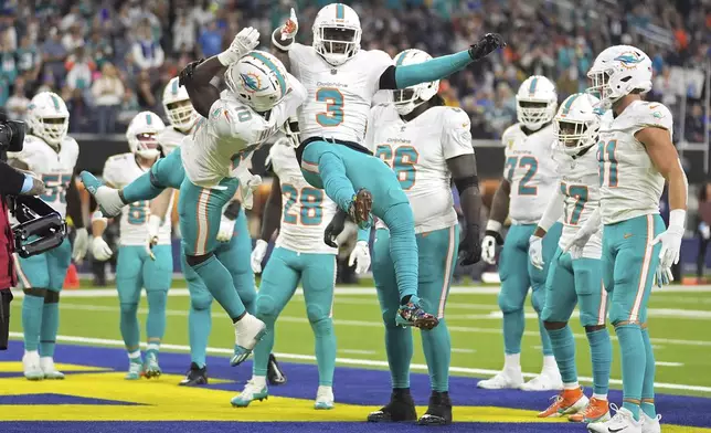 Miami Dolphins wide receiver Tyreek Hill, left, celebrates his touchdown with wide receiver Odell Beckham Jr. during the second half of an NFL football game against the Los Angeles Rams, Monday, Nov. 11, 2024, in Inglewood, Calif. (AP Photo/Marcio Jose Sanchez)