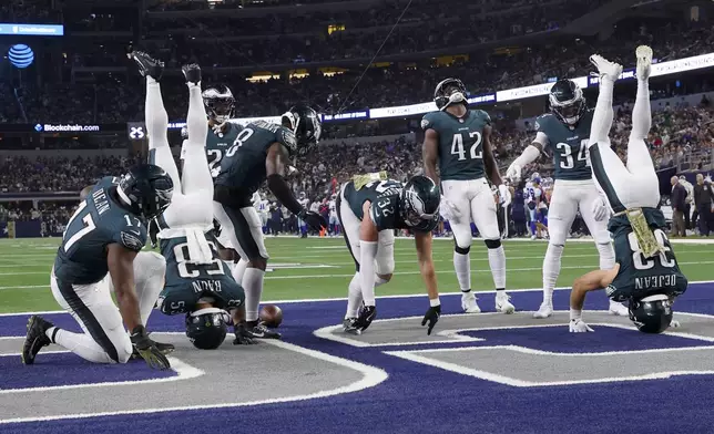 Philadelphia Eagles' Zack Baun (53) and Cooper DeJean, right, celebrate with teammates after they recovered a Dallas Cowboys fumble in the second half of an NFL football game in Arlington, Texas, Sunday, Nov. 10, 2024. (AP Photo/Richard Rodriguez)