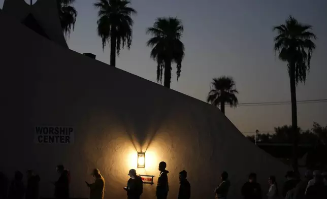 Voters stand in line outside a polling place at Madison Church, Tuesday, Nov. 5, 2024, in Phoenix, Ariz. (AP Photo/Matt York)