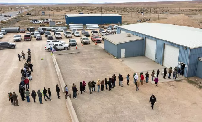 Voters wait in line to cast their ballots outside a polling station on the Navajo Nation in Chinle, Ariz., on Election Day, Tuesday, Nov. 5, 2024. (AP Photo/Andres Leighton)