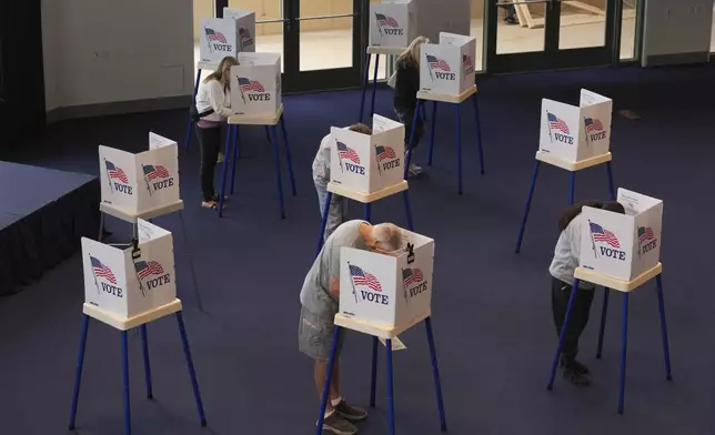 Voters work on their ballots at a polling place at the Ronald Reagan Presidential Library on Election Day, Tuesday, Nov. 5, 2024, in Simi Valley, Calif. (AP Photo/Chris Pizzello)