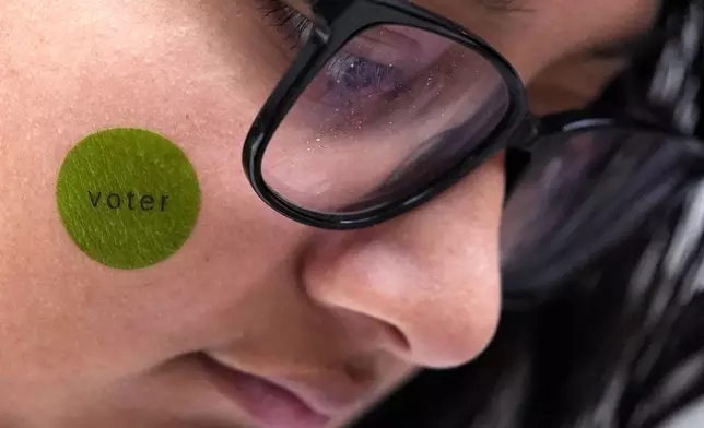 Hirieth Cervantes, freshman music major in Columbia College Chicago, waits to vote outside Chicago City Loop Super Site polling place on Election Day in Chicago, Tuesday, Nov. 5, 2024. (AP Photo/Nam Y. Huh)