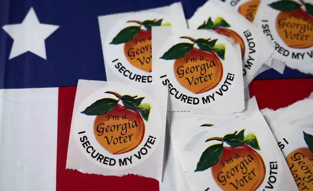 Stickers lay on a table inside a polling place, Tuesday, Nov. 5, 2024, in Atlanta. (AP Photo/Brynn Anderson)