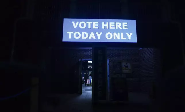 A poll worker sets up before a polling place opens, Tuesday, Nov. 5, 2024, in Atlanta.(AP Photo/Brynn Anderson)