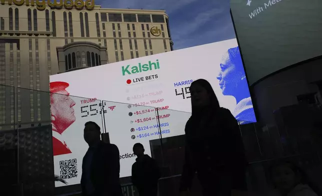 Betting odds on Presidential election results are displayed on screens along The Strip, Tuesday, Nov. 5, 2024, in Las Vegas. (AP Photo/John Locher)