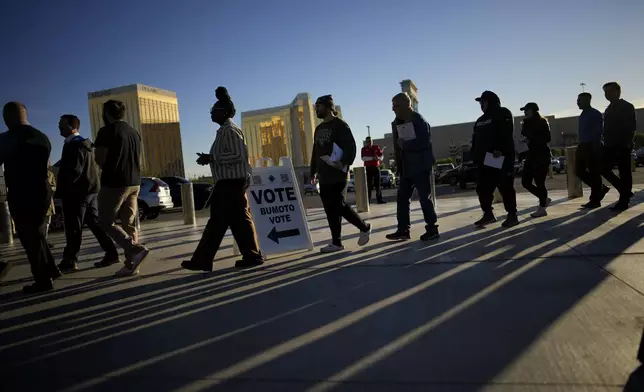 People line up to vote outside Allegiant Stadium, Tuesday, Nov. 5, 2024, in Las Vegas. (AP Photo/John Locher)