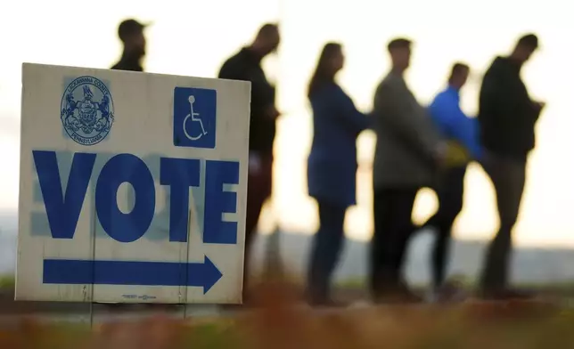 Voters wait in line to cast their ballots at Scranton High School in Scranton, Pa., on Election Day, Tuesday, Nov. 5, 2024. (AP Photo/Matt Rourke)