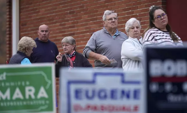 Voters stand in line while waiting for a polling place to open, Tuesday, Nov. 5, 2024, in Springfield, Pa. (AP Photo/Matt Slocum)