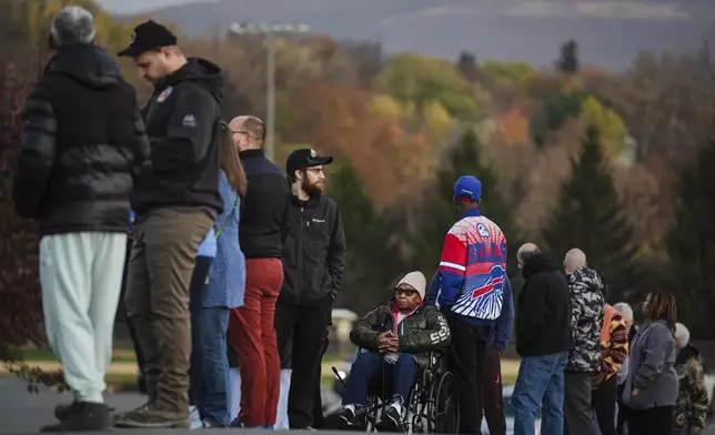 Liza Fortt, 74, center, waits in line to cast her ballot for Democratic presidential nominee Vice President Kamala Harris at her polling place at Scranton High School in Scranton, Pa., on Election Day, Tuesday, Nov. 5, 2024. (AP Photo/Matt Rourke)