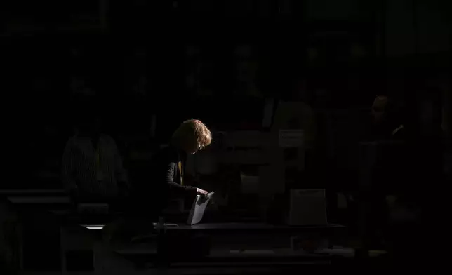 An election worker processes mail-in ballots for the 2024 General Election at the Philadelphia Election Warehouse, Tuesday, Nov. 5, 2024, in Philadelphia. (AP Photo/Matt Slocum)