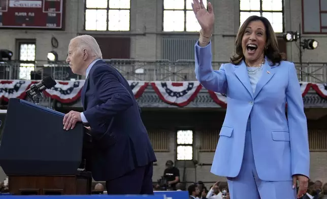 President Joe Biden speaks as Vice President Kamala Harris waves at a campaign event at Girard College, Wednesday, May 29, 2024, in Philadelphia. (AP Photo/Evan Vucci)