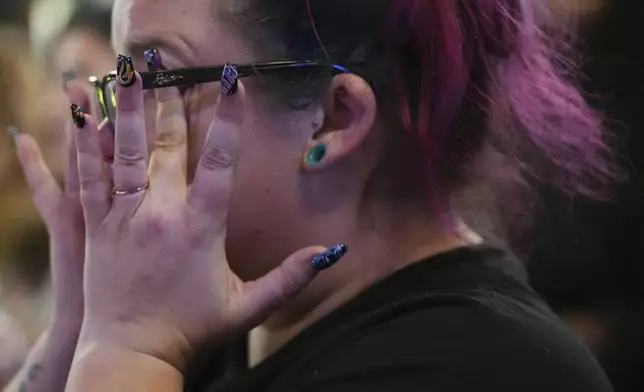 Emmie Reed, center, co-founder of Bans Off Our Bodies Florida collective, wipes away tears after Florida's Amendment 4, which would have enshrined abortion rights in the state, fell short of the 60% vote threshold required to pass, during a watch party for the Yes On 4 campaign, on Election Day, Tuesday, Nov. 5, 2024, in St. Petersburg, Fla. (AP Photo/Rebecca Blackwell)