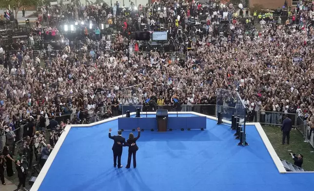 Vice President Kamala Harris, right, and her husband, second gentleman Doug Emhoff, wave after her concession speech for the 2024 presidential election on the campus of Howard University in Washington, Wednesday, Nov. 6, 2024. (AP Photo/David J. Phillip)