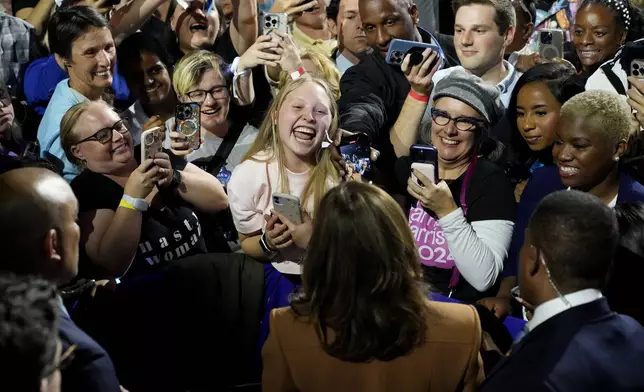 Democratic presidential nominee Vice President Kamala Harris, bottom center, greets supporters after speaking during a campaign rally at the Wings Event Center in Kalamazoo, Mich. (AP Photo/Jacquelyn Martin)