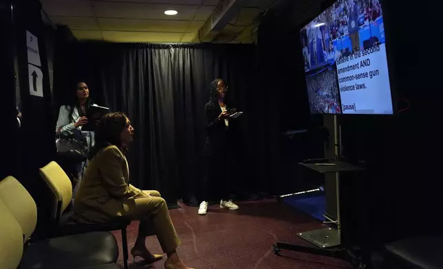 Democratic presidential nominee Vice President Kamala Harris sits backstage as she listens to running mate Minnesota Gov. Tim Walz speak at a campaign rally at Desert Diamond Arena, Friday, Aug. 9, 2024, in Glendale, Ariz. (AP Photo/Julia Nikhinson)