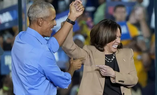 Former President Barack Obama gestures to Democratic presidential nominee Vice President Kamala Harris after introducing her to speak during a campaign rally for Harris on Thursday, Oct. 24, 2024, in Clarkston, Ga. (AP Photo/Mike Stewart)