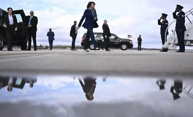 Democratic presidential nominee Vice President Kamala Harris walks to board Air Force Two before departing Dane County Regional Airport in Madison, Wis., Thursday, Oct. 31, 2024. (Brendan Smialowski/ Pool via AP)