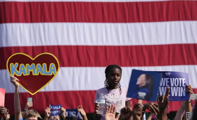 Supporters watch as Democratic presidential nominee Vice President Kamala Harris speaks during a campaign rally outside the Atlanta Civic Center, Saturday, Nov. 2, 2024. (AP Photo/Brynn Anderson)