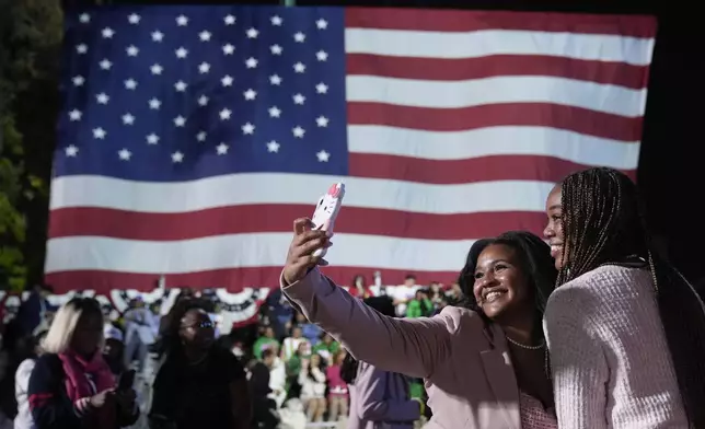 Supporters of Democratic presidential nominee Vice President Kamala Harris pose for a photo while attending her election night campaign watch party Tuesday, Nov. 5, 2024, on the campus of Howard University in Washington. (AP Photo/Mark Schiefelbein)