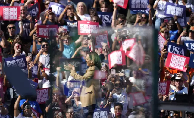 Democratic presidential nominee Vice President Kamala Harris, pictured through bullet-resistant glass, arrives to speak during a campaign rally outside the Atlanta Civic Center, Saturday, Nov. 2, 2024. (AP Photo/Brynn Anderson)