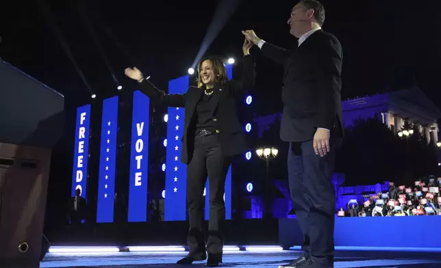 Democratic presidential nominee Vice President Kamala Harris, left, and second gentleman Doug Emhoff depart at the conclusion of a campaign rally outside the Philadelphia Museum of Art, Monday, Nov. 4, 2024, in Philadelphia. (AP Photo/Jacquelyn Martin)