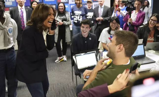 Democratic presidential nominee Vice President Kamala Harris, left, reacts as she phone banks with volunteers at the DNC headquarters on Election Day, Tuesday, Nov. 5, 2024, in Washington. (AP Photo/Jacquelyn Martin)