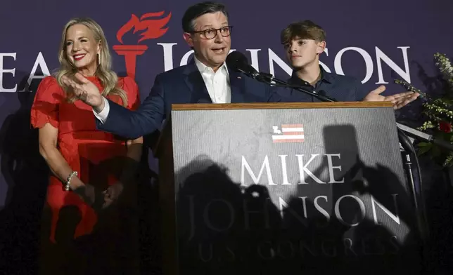 House Speaker Mike Johnson, R-La., joined his wife Kelly, left, speaks during an election night watch party Tuesday, Nov. 5, 2024, in Shreveport, La. (AP Photo/Matthew Hinton)