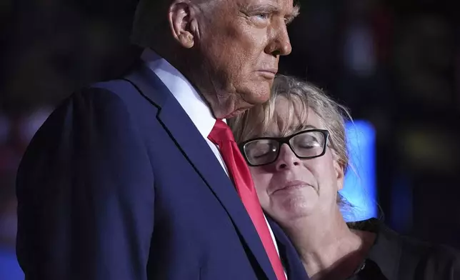 Republican presidential nominee former President Donald Trump embraces Patty Morin, mother of Rachel Morin, during a campaign rally at Santander Arena, Monday, Nov. 4, 2024, in Reading, Pa. (AP Photo/Evan Vucci)