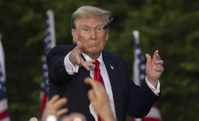 Republican presidential candidate former President Donald Trump throws a pen during a campaign rally in the south Bronx, Thursday, May. 23, 2024, in New York. (AP Photo/Yuki Iwamura)