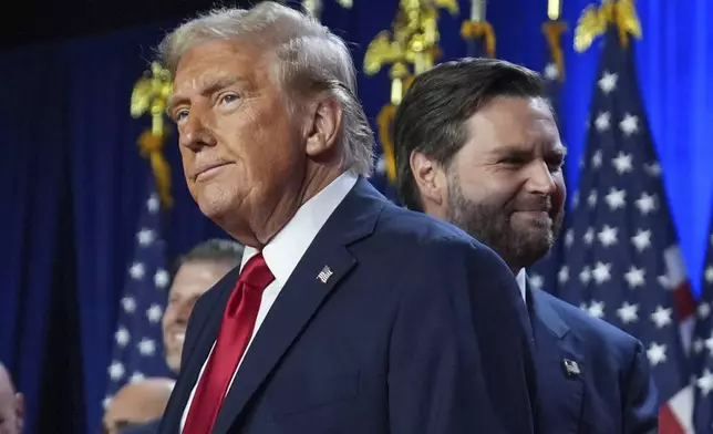 Republican presidential nominee former President Donald Trump and his running mate Sen. JD Vance, R-Ohio, stand on stage at an election night watch party at the Palm Beach Convention Center, Wednesday, Nov. 6, 2024, in West Palm Beach, Fla. (AP Photo/Evan Vucci)