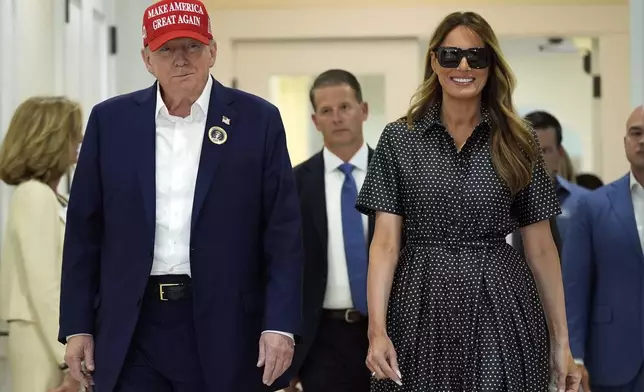 Republican presidential nominee former President Donald Trump and former first lady Melania Trump walk after voting on Election Day at the Morton and Barbara Mandel Recreation Center, Tuesday, Nov. 5, 2024, in Palm Beach, Fla. (AP Photo/Evan Vucci)