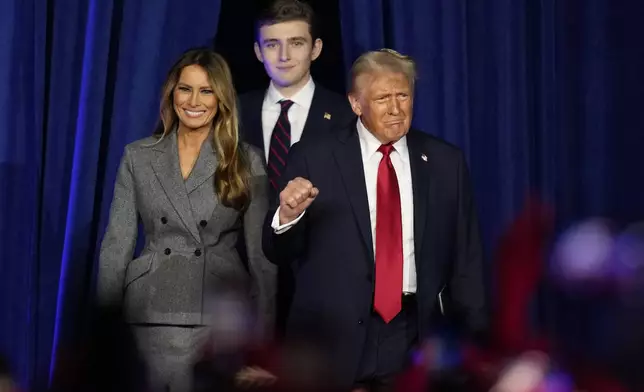 Republican presidential nominee former President Donald Trump, joined by, from right, Melania Trump and Barron Trump, arrives to speaks at an election night watch party, Wednesday, Nov. 6, 2024, in West Palm Beach, Fla. (AP Photo/Alex Brandon)