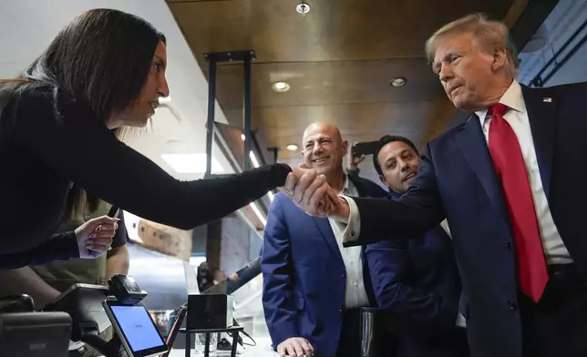 Republican presidential nominee former President Donald Trump greets people as he visits The Great Commoner, Friday, Nov. 1, 2024, in Dearborn, Mich. (AP Photo/Julia Demaree Nikhinson)