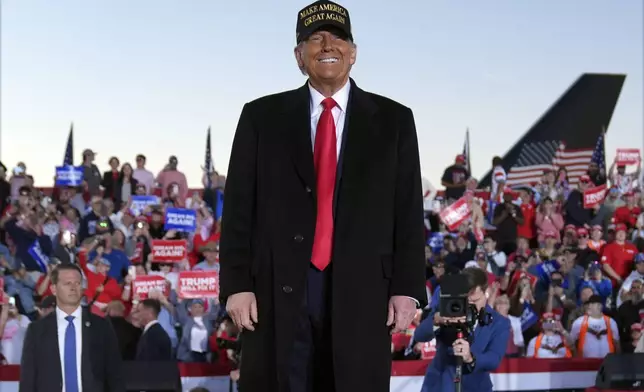 Republican presidential nominee former President Donald Trump smiles at a campaign rally at Kinston Regional Jetport, Sunday, Nov. 3, 2024, in Kinston, N.C. (AP Photo/Evan Vucci)