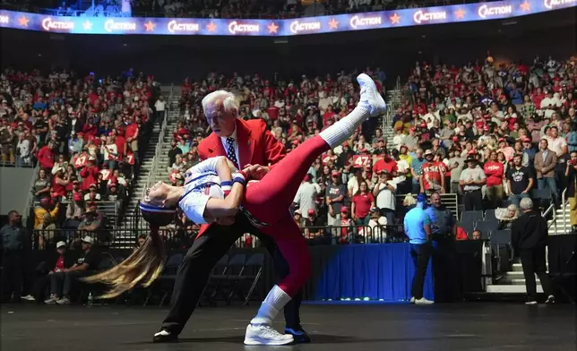 Gary Bruce and Brittany Kemper dance before Republican presidential nominee former President Donald Trump speaks at a Turning Point Action campaign rally, Wednesday, Oct. 23, 2024, in Duluth, Ga. (AP Photo/Alex Brandon)