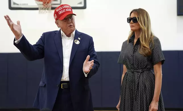 Republican presidential nominee former President Donald Trump speaks as former first lady Melania Trump listens after they voted on Election Day at the Morton and Barbara Mandel Recreation Center, Tuesday, Nov. 5, 2024, in Palm Beach, Fla. (AP Photo/Evan Vucci)