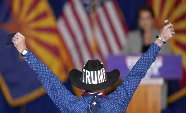 A supporter of former President Donald Trump cheers on Republican Arizona Senate candidate Kari Lake as the crowd waits for vice presidential nominee Sen. JD Vance, R-Ohio, to speak at a campaign rally, Saturday, Nov. 2, 2024, in Scottsdale, Ariz. (AP Photo/Ross D. Franklin)