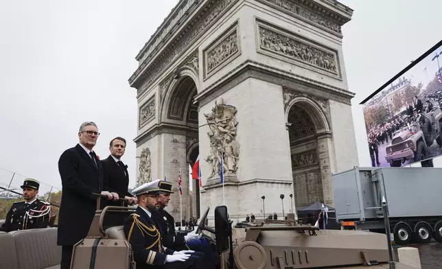 French President Emmanuel Macron, second left, and Britain's Prime Minister Keir Starmer look on upon their arrival on the Arc de Triomphe to attend commemorations marking the 106th anniversary of the November 11, 1918, Armistice, ending World War I, in Paris, Monday, Nov. 11, 2024. ( Ludovic Marin, Pool via AP)