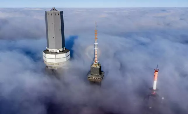 Telekom devices are surrounded by clouds on top of the Feldberg mountain near Frankfurt, Germany, Thursday, Nov. 7, 2024. (AP Photo/Michael Probst)